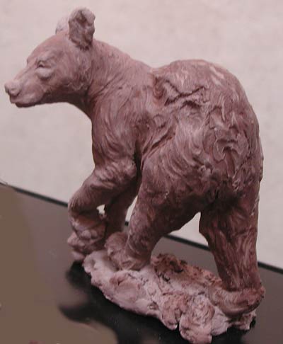 Black bear cub sculpture shown in clay