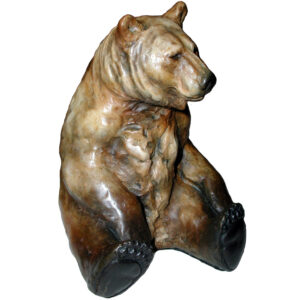 Miniature bronze grizzly bear sitting relaxed