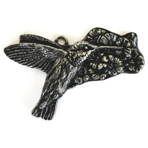 Silver-toned metal ornament of a hummingbird at a flower