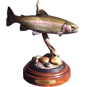 Hand-painted bronze rainbow trout leaping above rocks on a round wood base