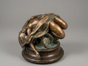 Bronze sculpture of a reclining draped figure on a round base, in a warm brown patina